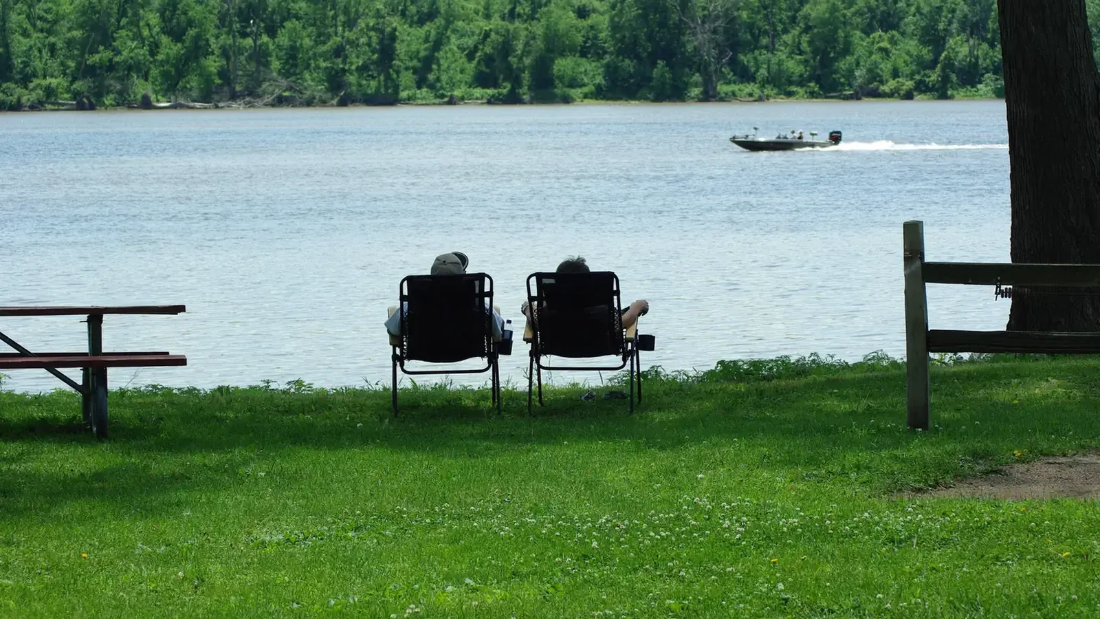 Lounging looking at the river with a speedboat going by.