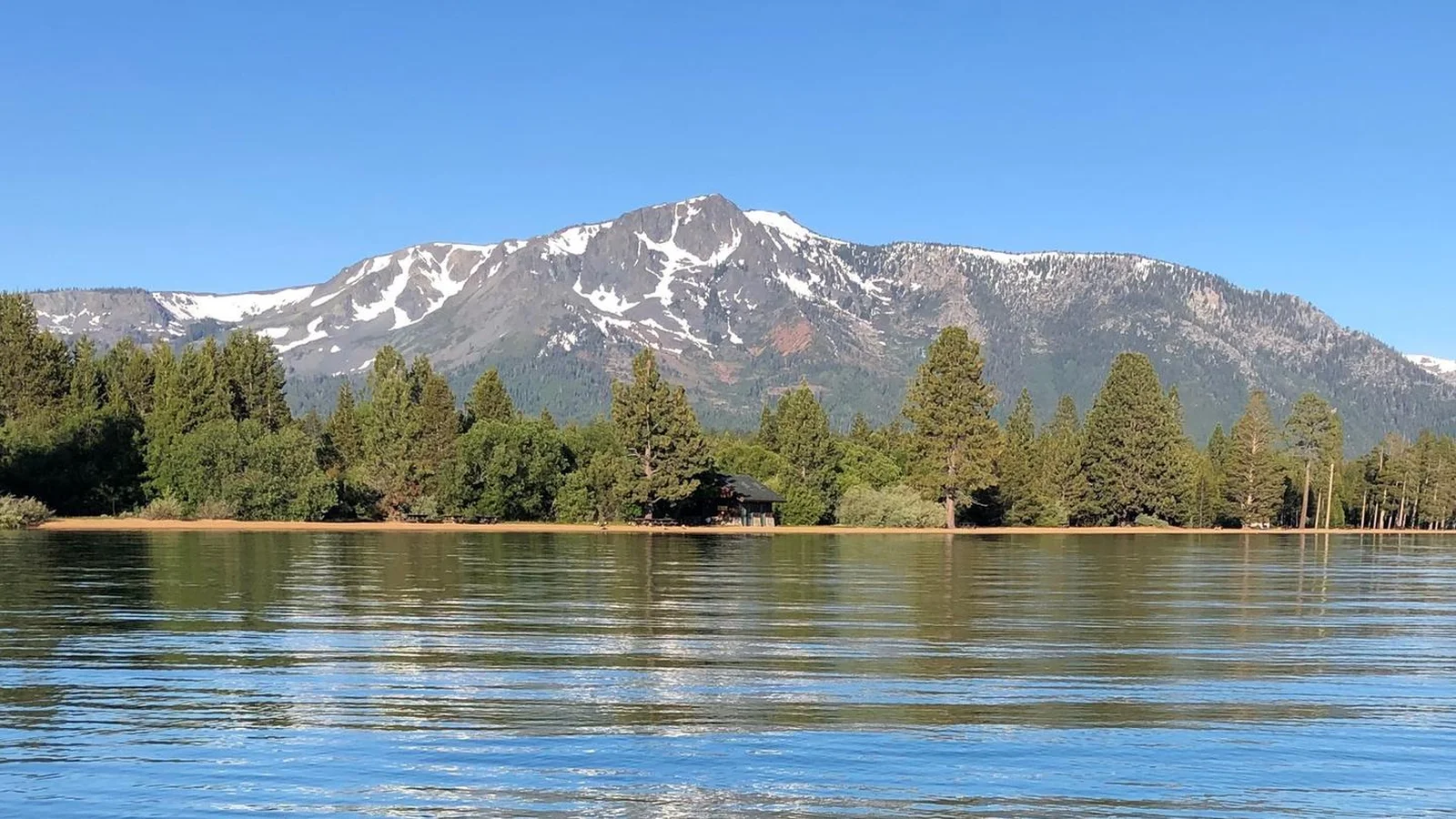 Lake Tahoe in the foreground looking towards the beaches on the West side of the lake with Mount Tallac in the background with a bit of snow.