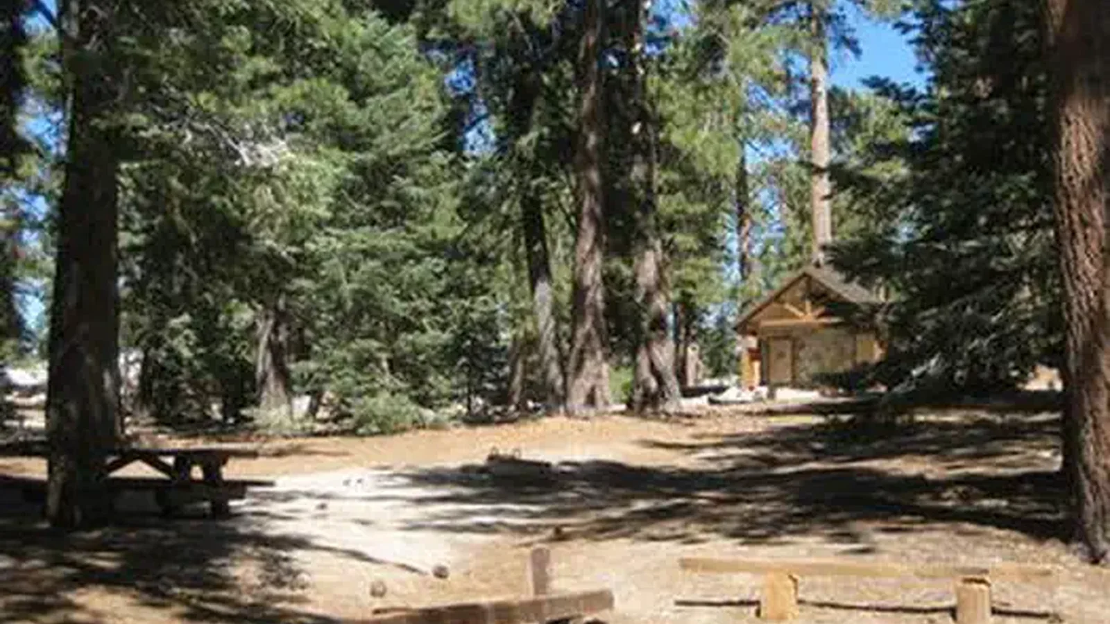 Campsite with picnic table and restroom.