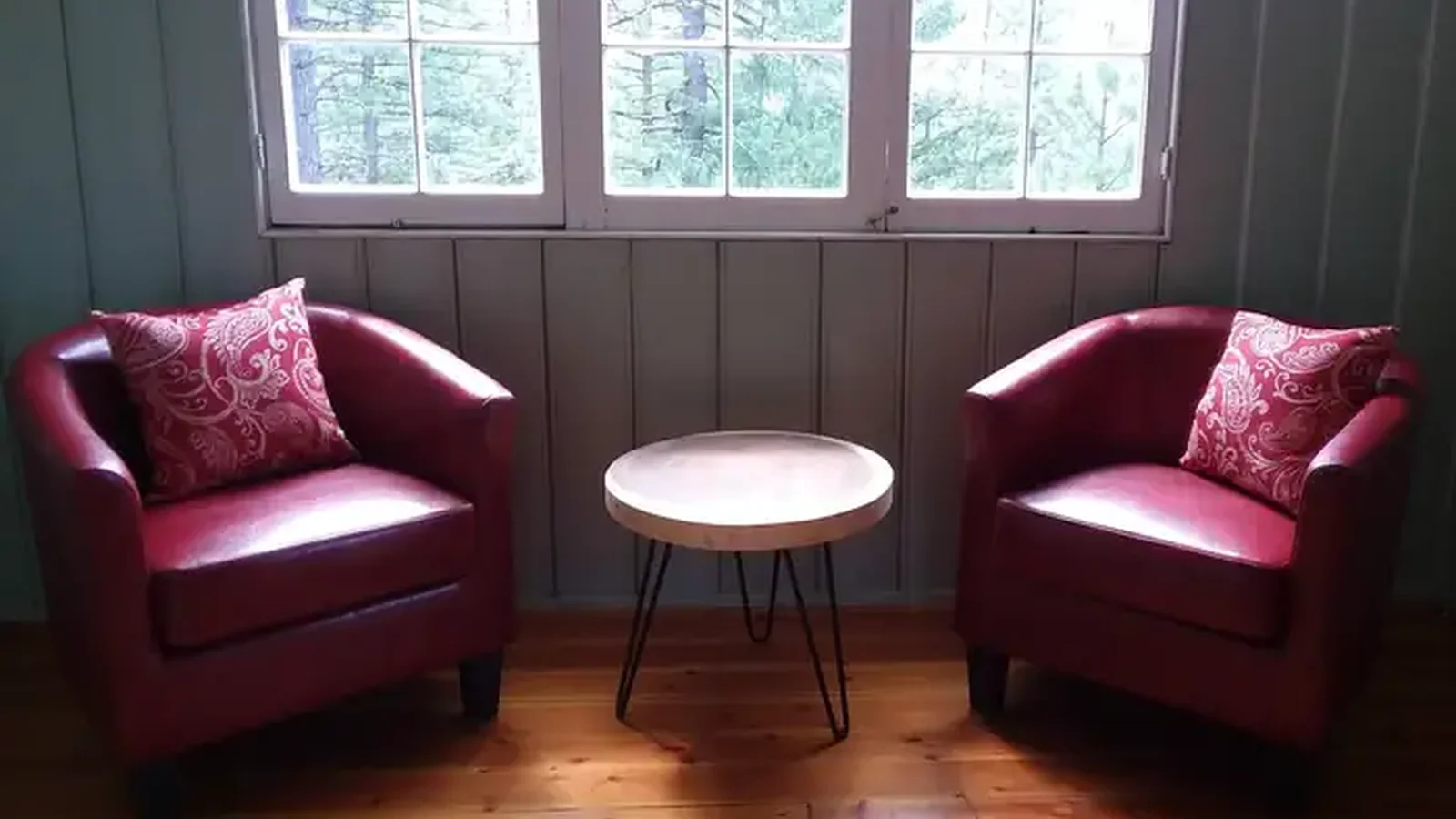 Two red chairs and a coffee table in living room.