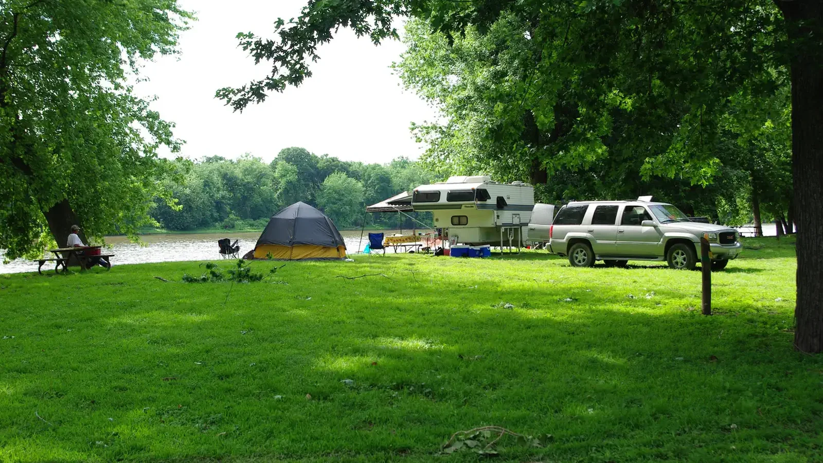 Popup Camper and Tent along river campsite