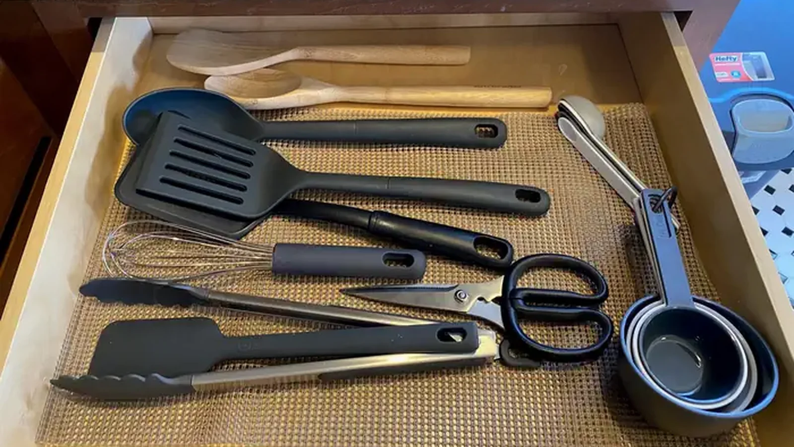 Cooking utensils include spatulas, mixing spoons and measuring cups.