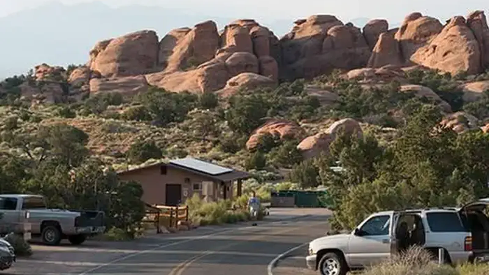 Campground road lined with campsites and boulders in the background.