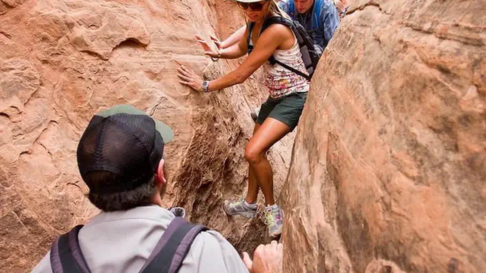 Visitors navigating a narrow passage in the Fiery Furnace.