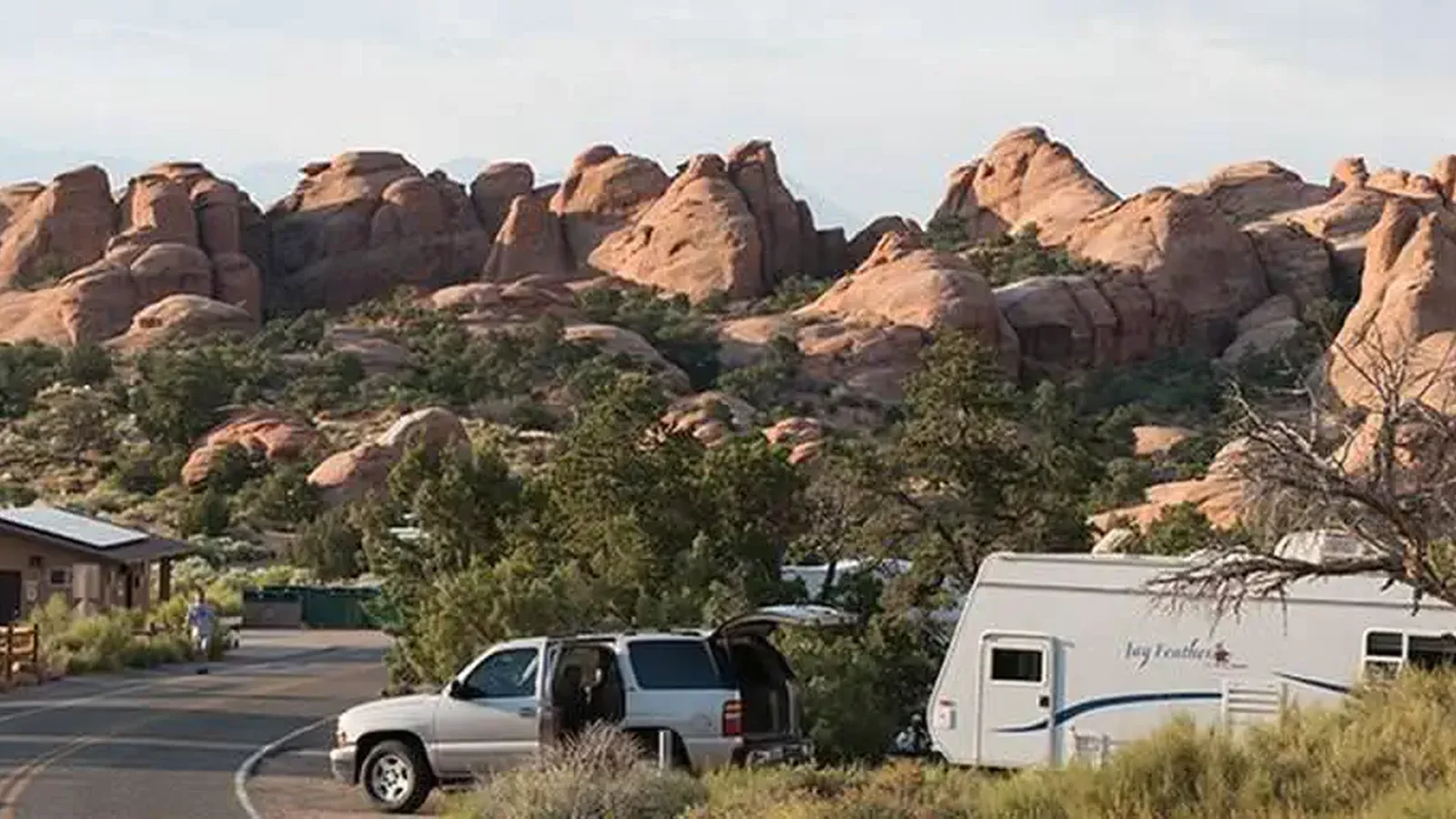Campground road lined with campsites and boulders in the background