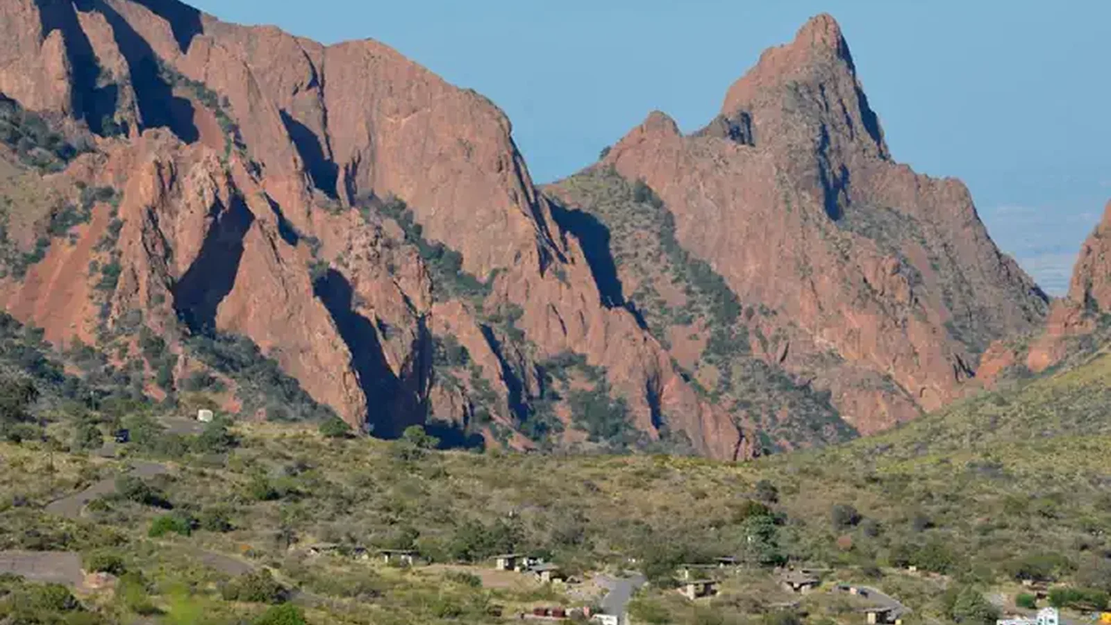 Chisos Basic Campground Area from a distance surrounded by mountain peaks