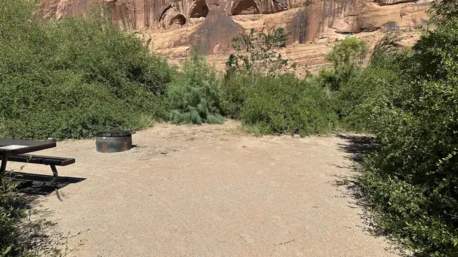 There is one picnic table and fire ring with views of the Colorado river and high sandstone cliffs.
