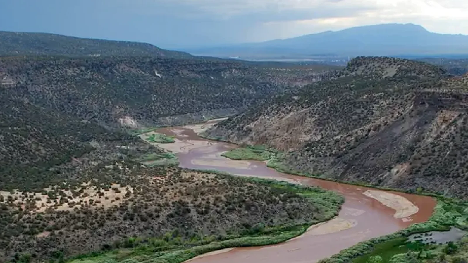 River flowing through a canyon with mountains in the distance