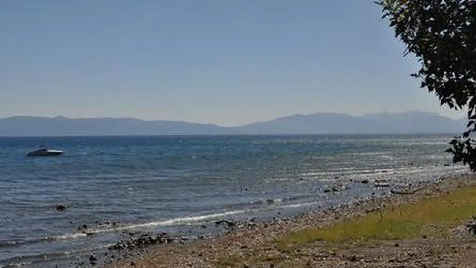 A rocky shoreline of a mountain lake