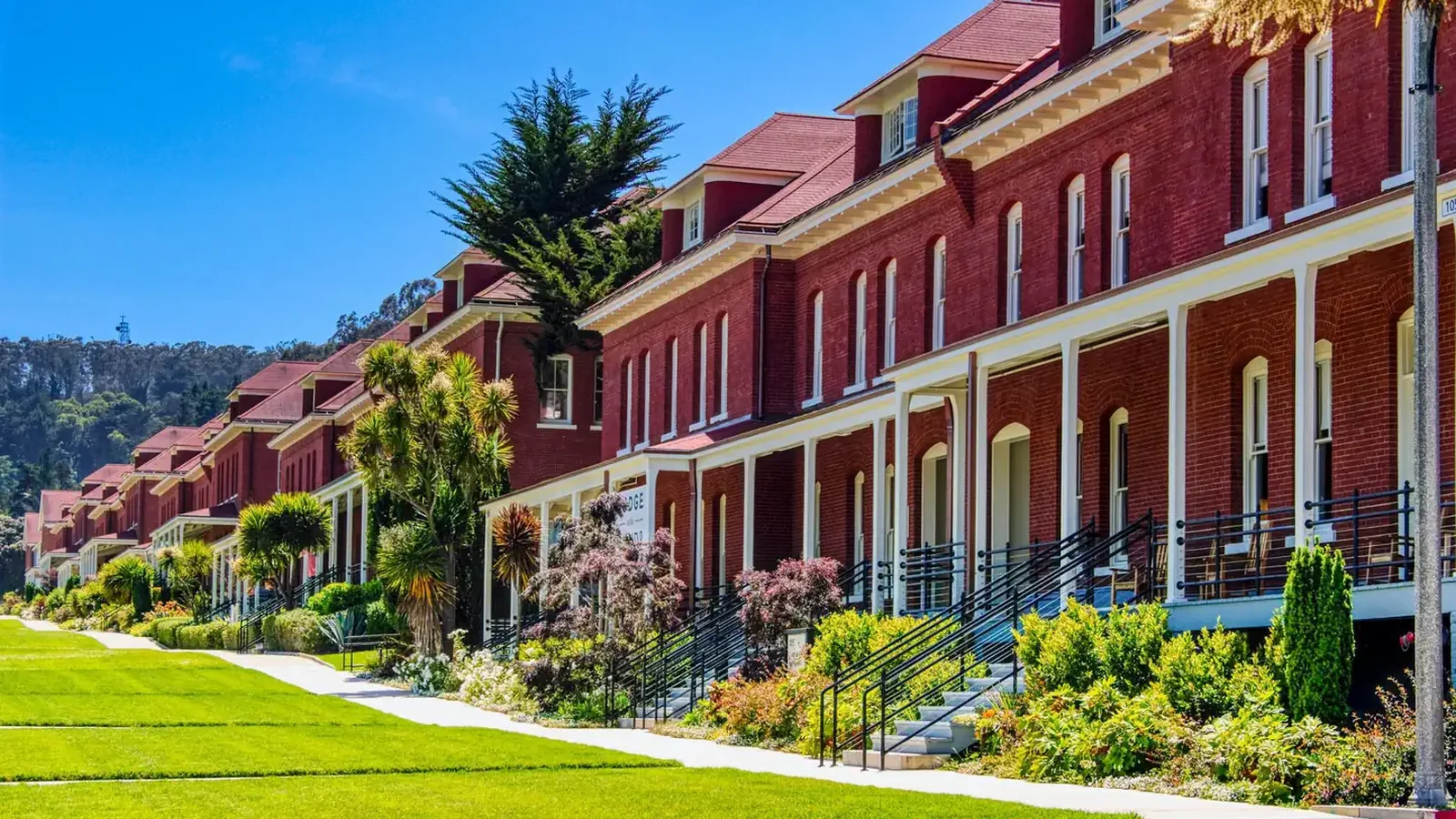 Red brick buildings with lawn.