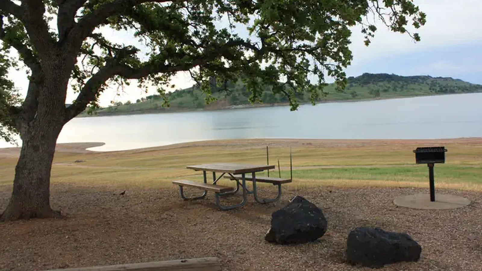 Day use area picnic site with table and barbecue pedestal.