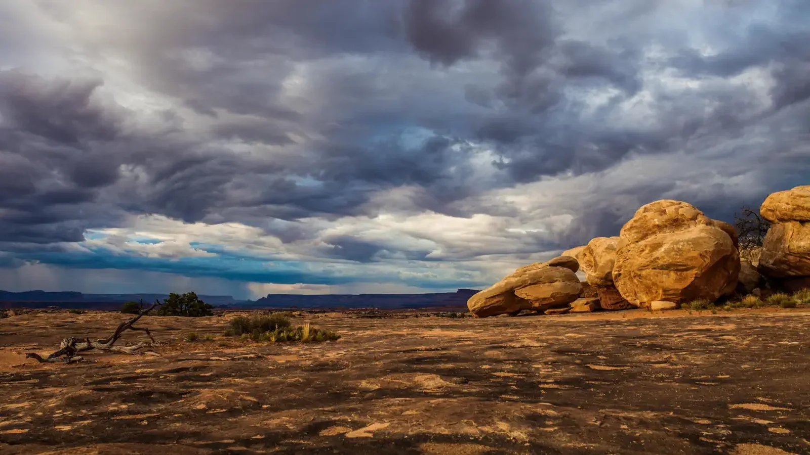 View of rock formations under storm clouds from Pothole Point in the Needles District