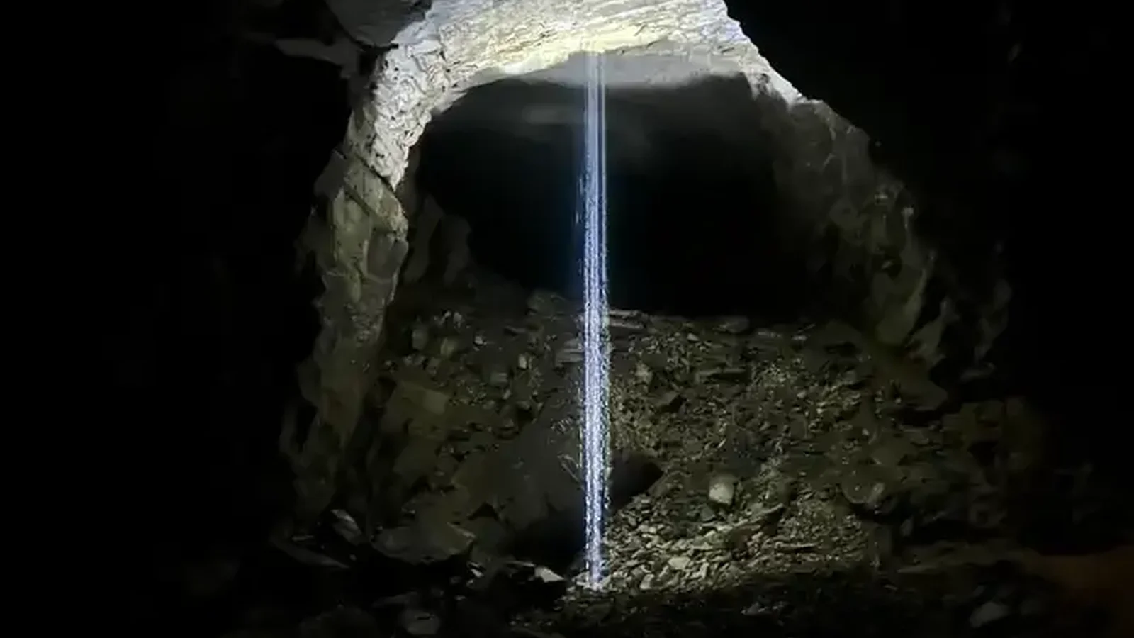 Waterfall in the cave lit up my a flashlight