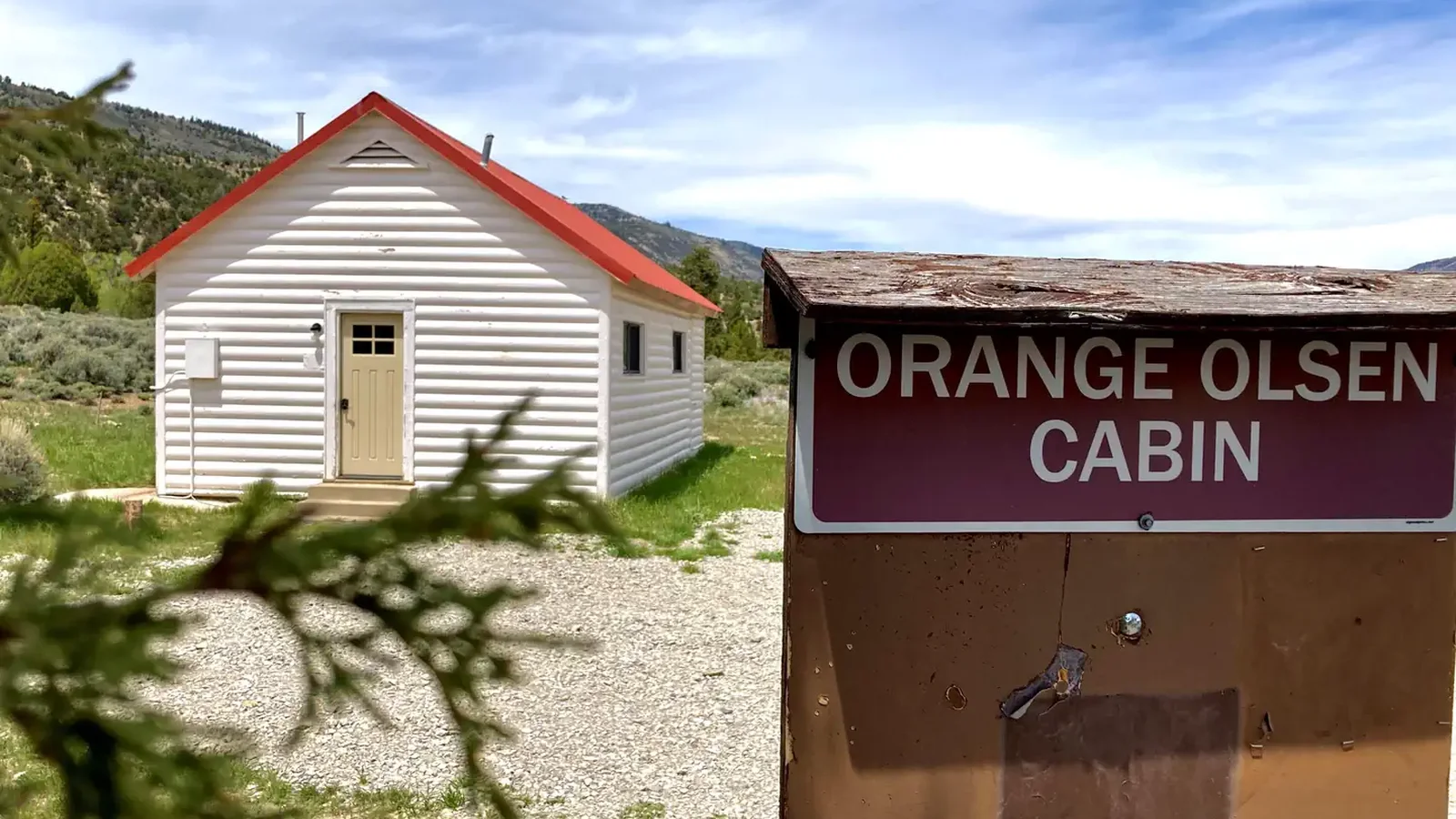 An Orange Olsen Cabin sign marks the structure.