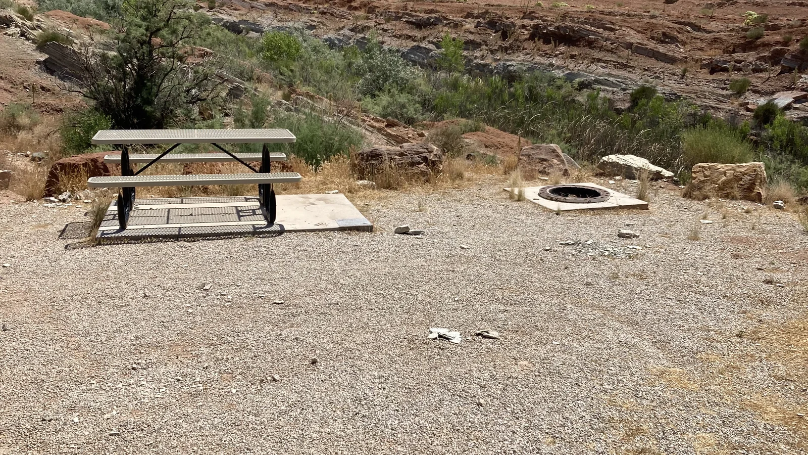 Gravel camping pad and picnic table at Quail Creek Reservoir Designated Dispersed Camping Area