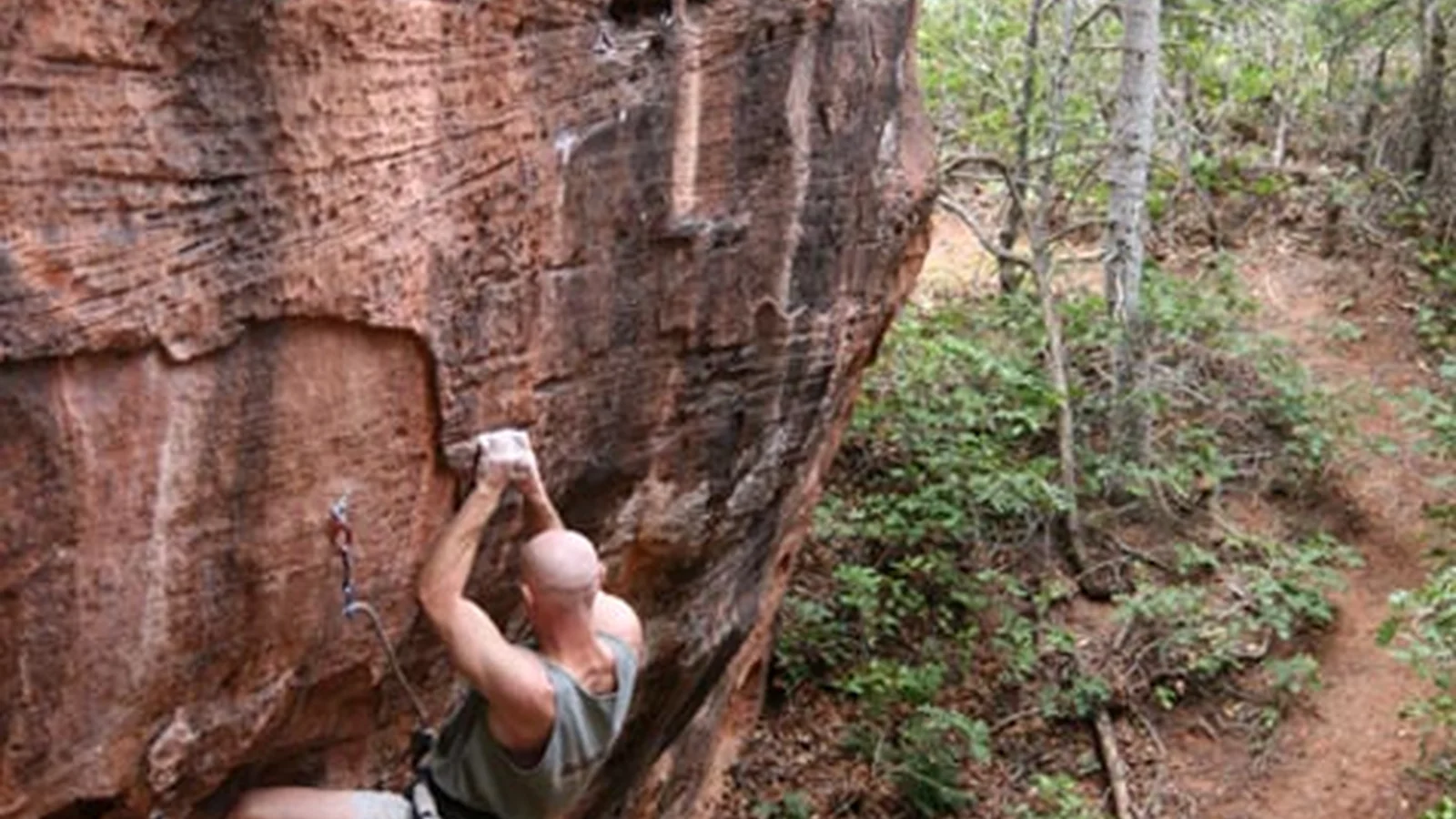Climber at Lambs Knoll Climbing Site with adjacent vegetation