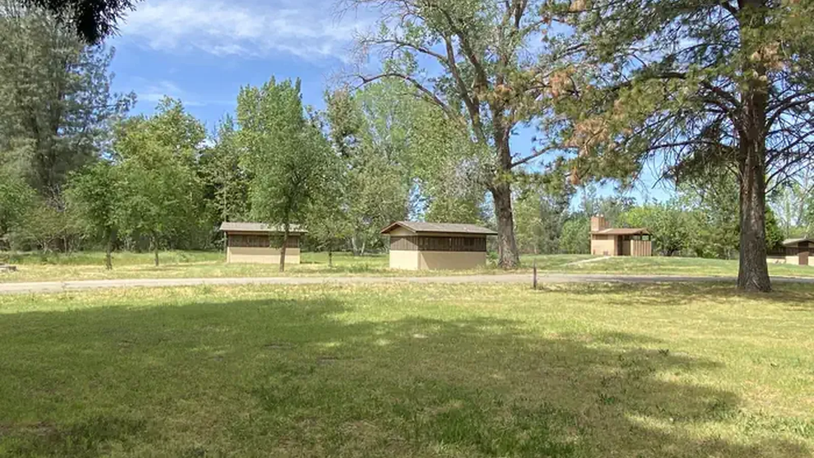 A group of sleeping cabins and vault toilet