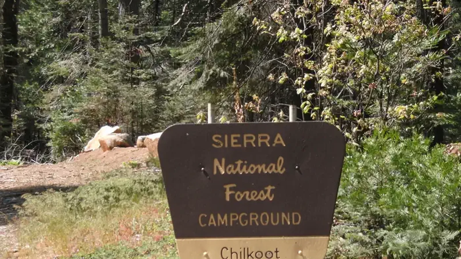 A brown and yellow Forest Sign for Chilkoot Campground on the Sierra National Forest