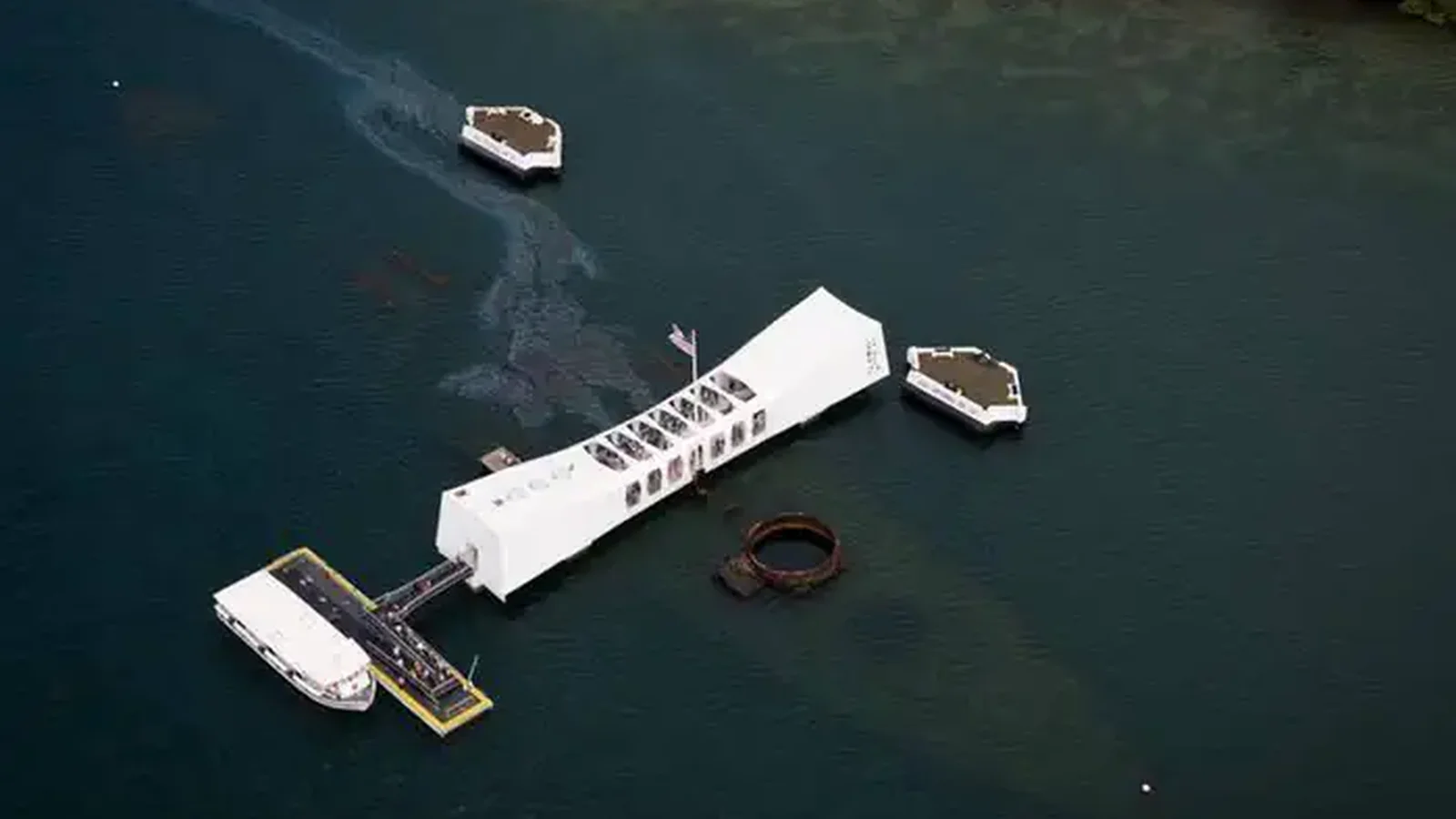 An aerial view of the USS Arizona Memorial over the sunken USS Arizona.
