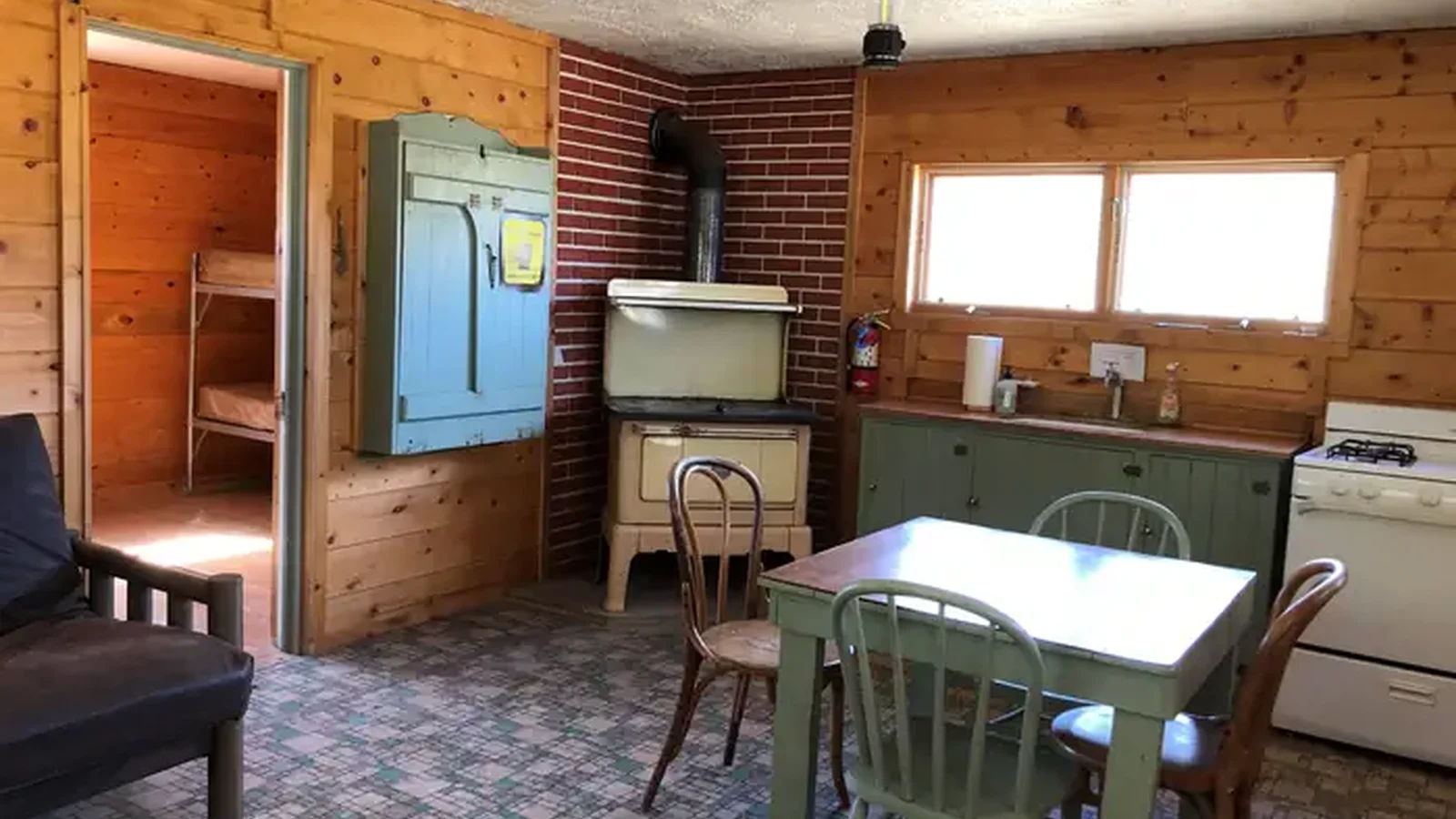 Woodstove, table and chairs, gas range and sink