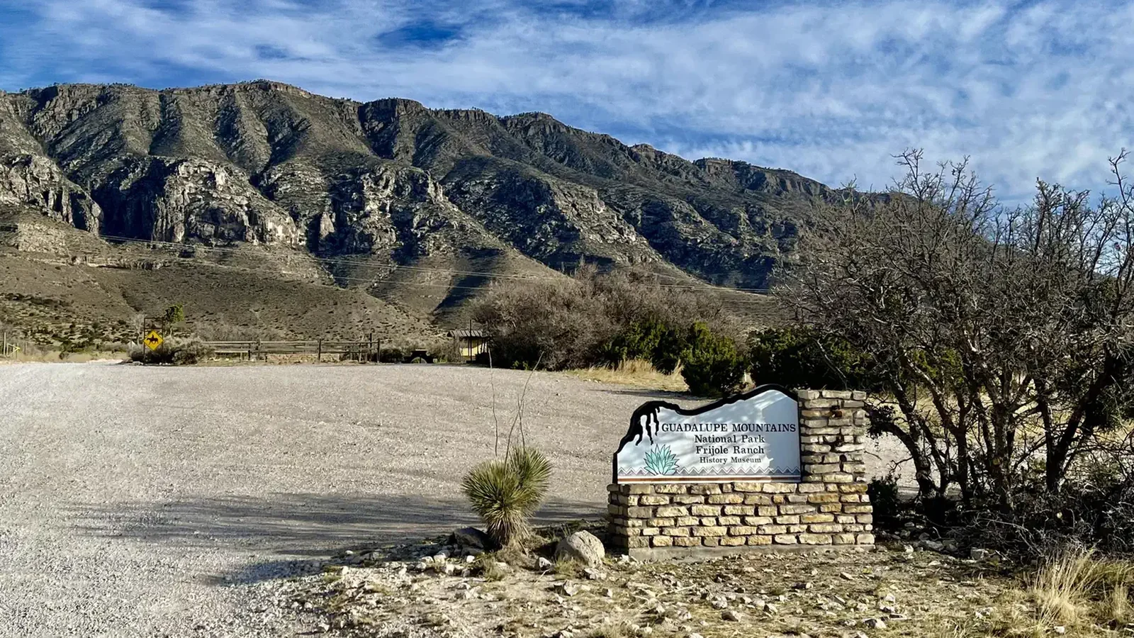 Entry sign to the Frijole Ranch area with view of the mountains in the background and the Frijole Horse Corral campground.