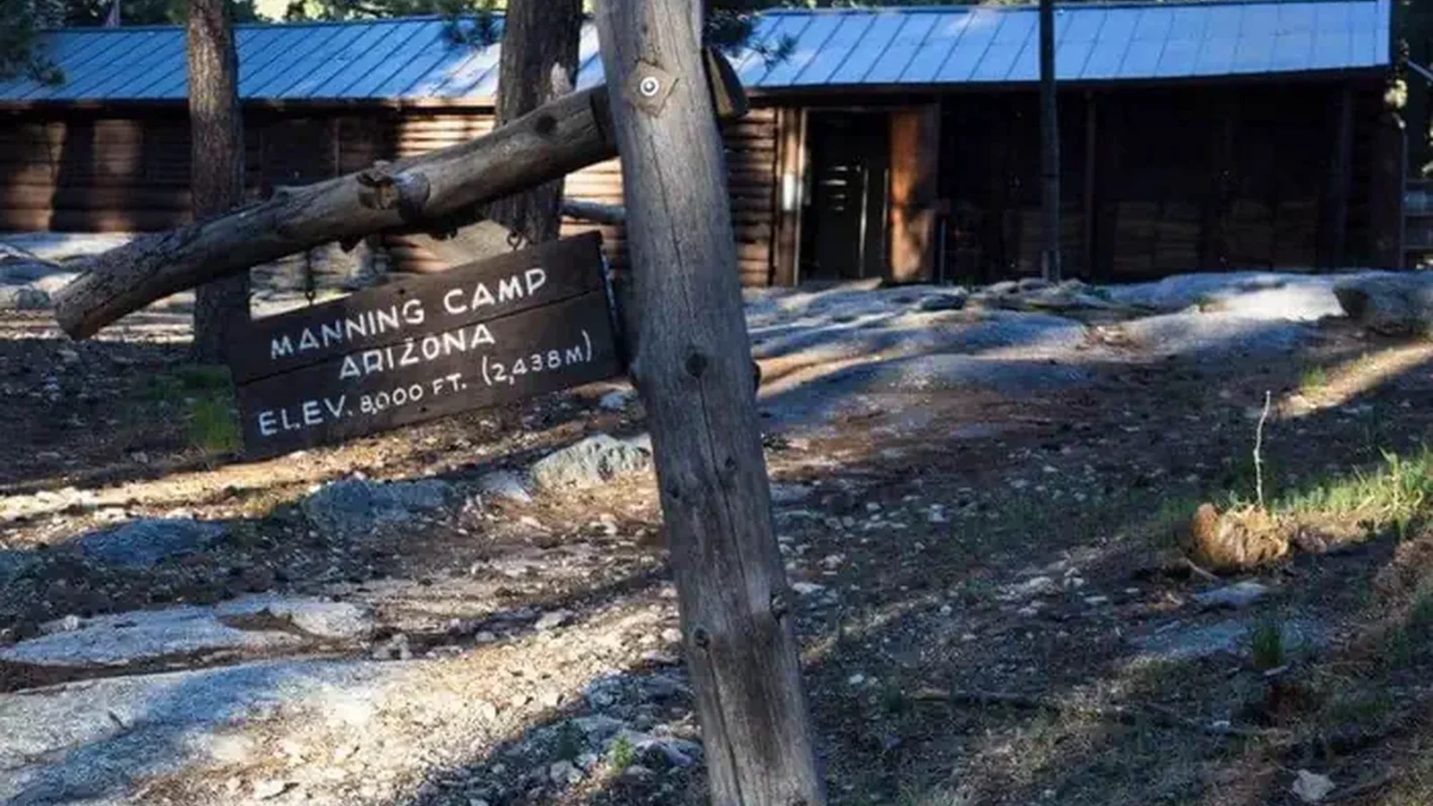 Manning Camp Cabin with 8,000 ft elevation sign
