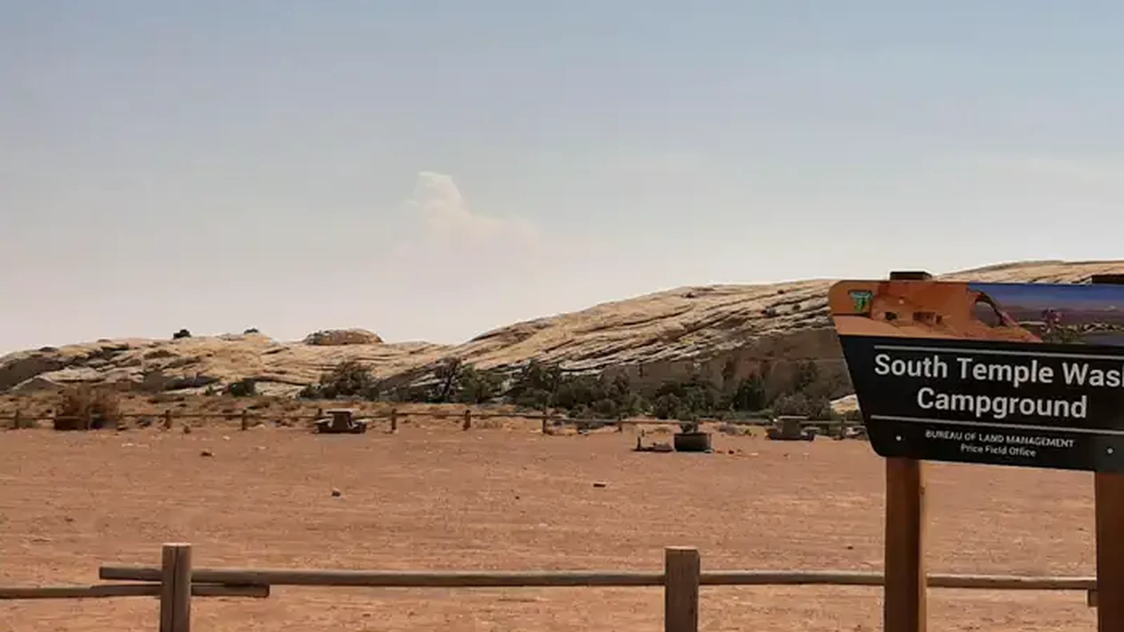 Wide angle photo of campground with sign in foreground that says "South Temple Wash"