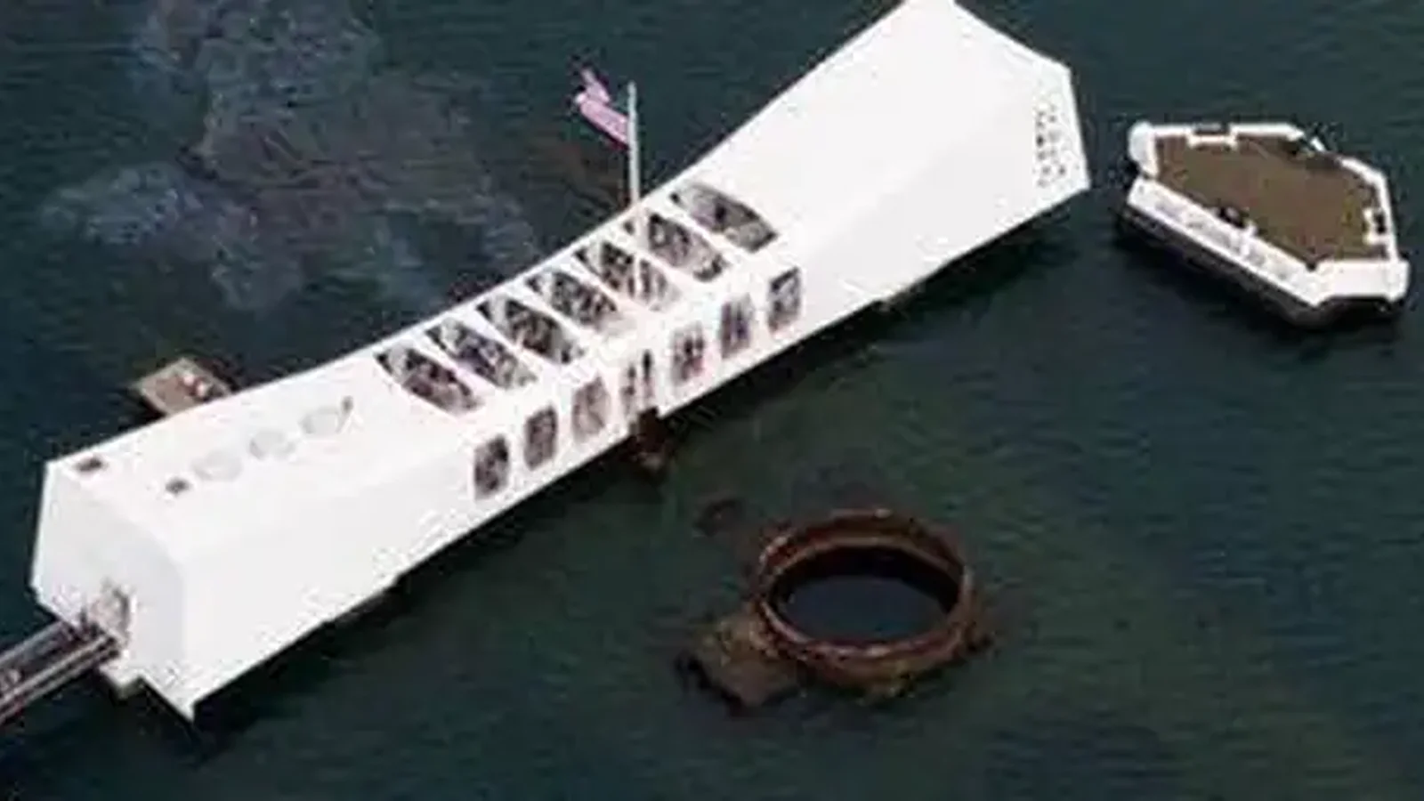 An aerial view of the USS Arizona Memorial over the sunken USS Arizona.