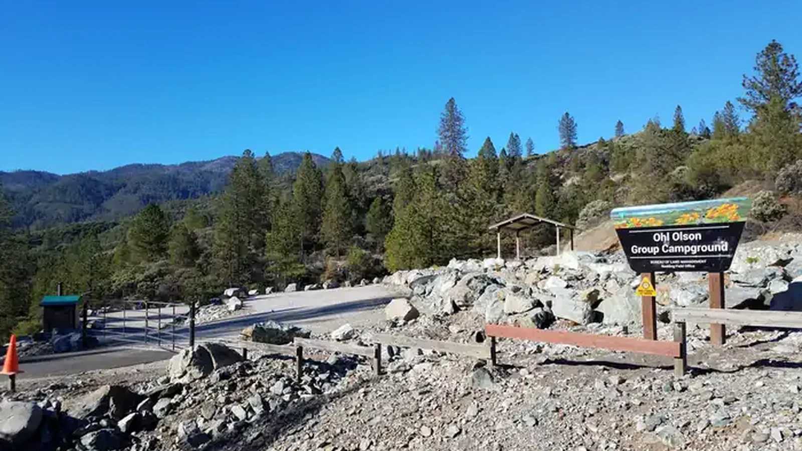 Campground entrance with gate, sign, and access road to the upper and lower site