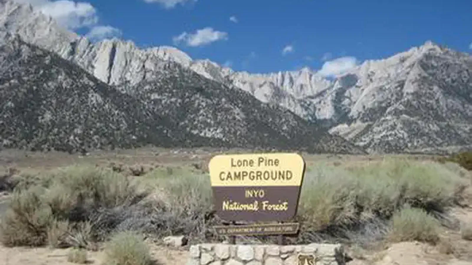 A brown and yellow Forest Service sign for Lone Pine Campground